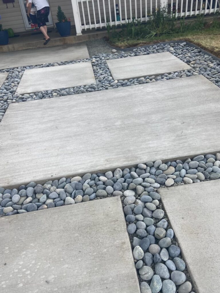 Concrete slabs separated by decorative river rock