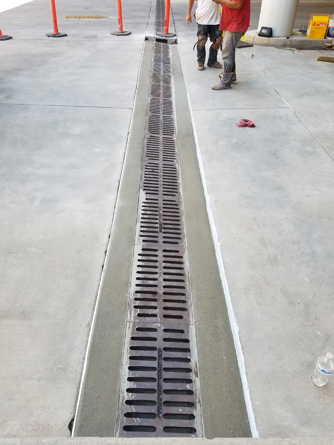 Long grated drain set into a concrete surface