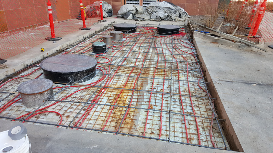 Reinforcement and tubing inside a prepared commercial concrete area