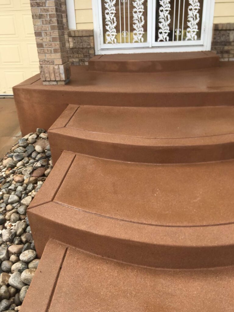 Curved colored concrete steps at a residential front entrance