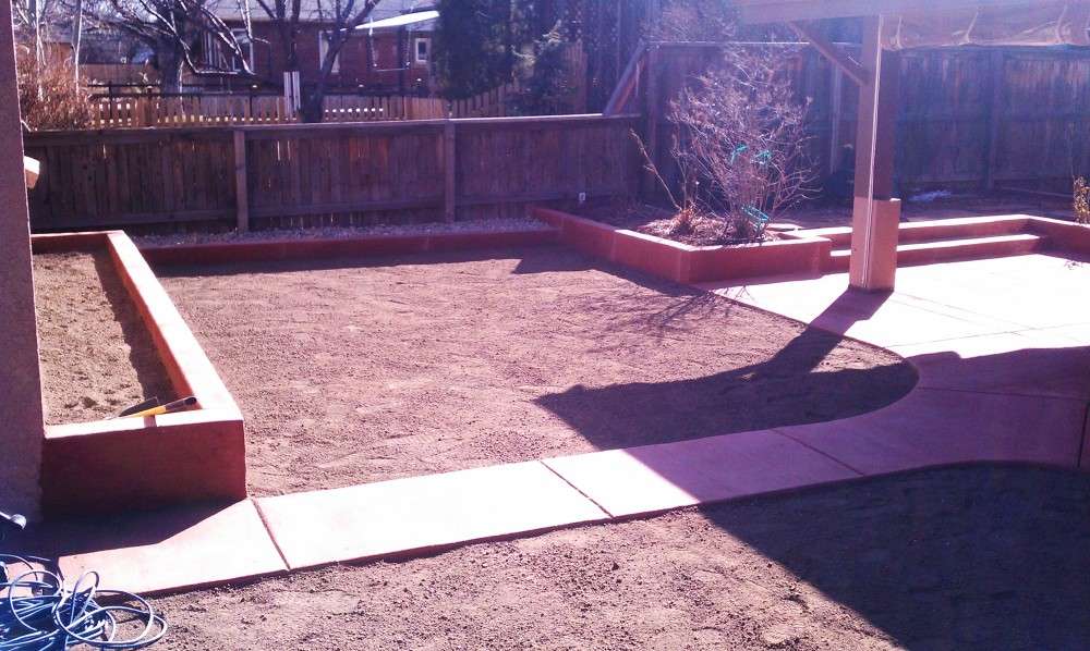 Concrete paths and colored edging around a residential backyard